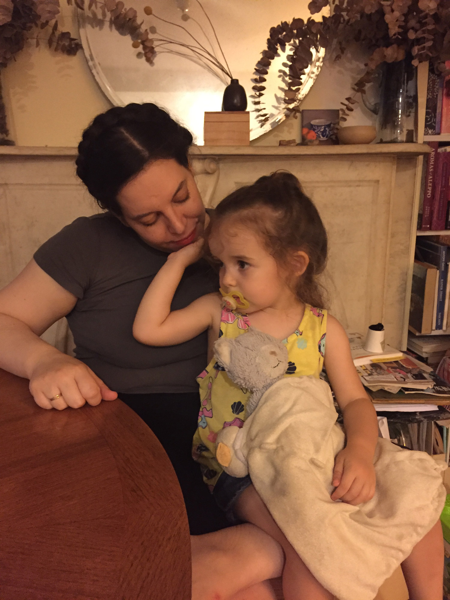 The author's sister holds her young child in a cozy living room